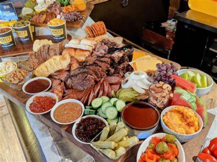 A beautiful spread of barbecue food including burgers and potato salad
