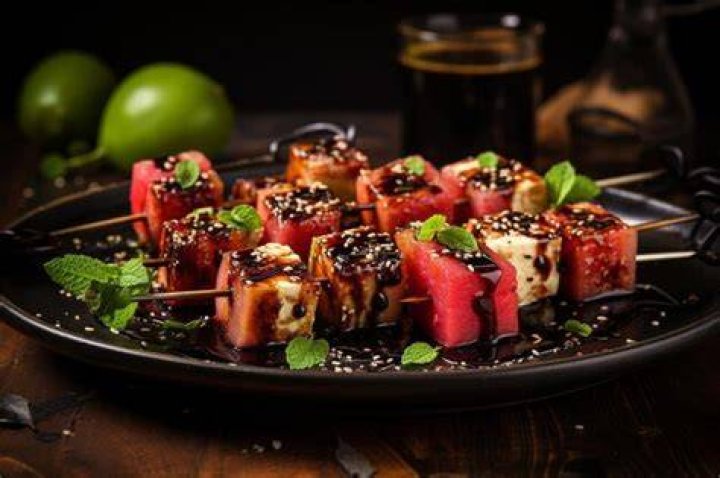 Grilled watermelon and feta skewers arranged artfully on a serving platter