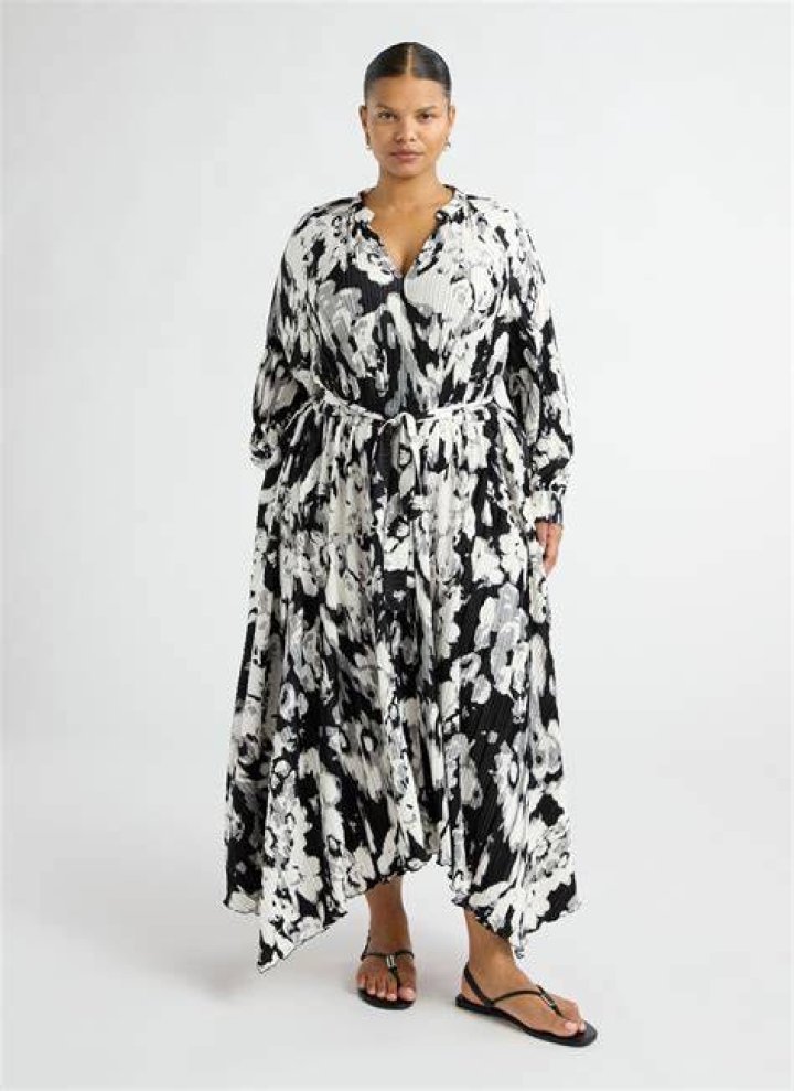 Person wearing a flowy floral midi dress at a barbecue