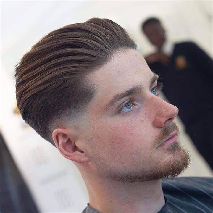 slicked back hairdo for men highlighting volume and sleekness