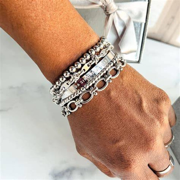 Stacked metal bracelets and festival accessories