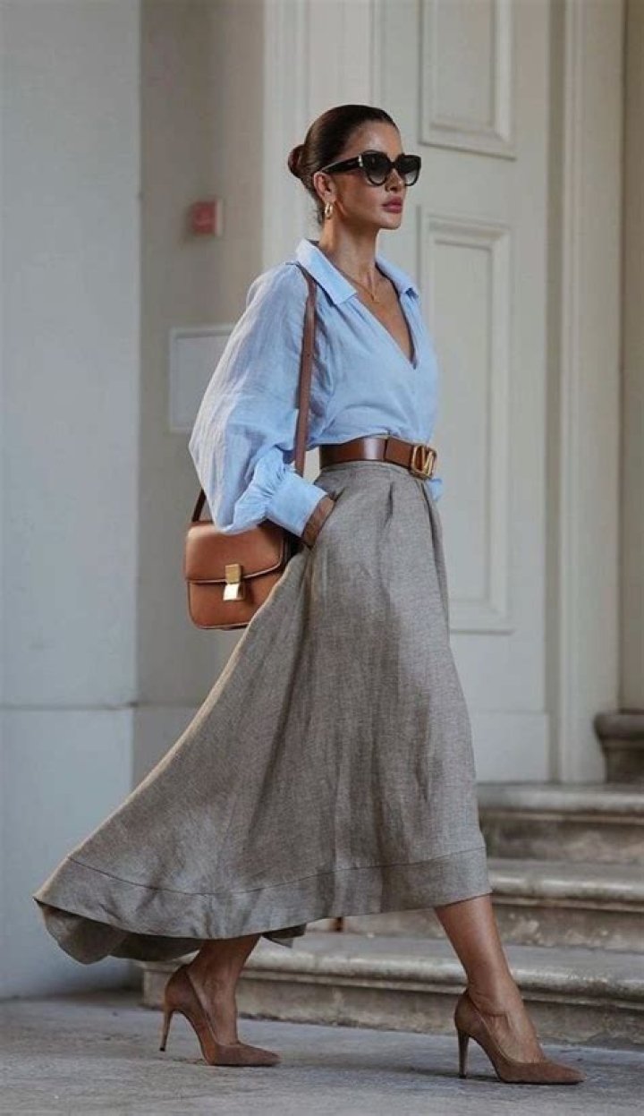 Stylish woman in a wrap dress walking outside