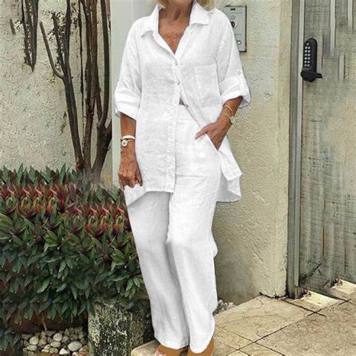 Woman in stylish linen summer outfit at a park