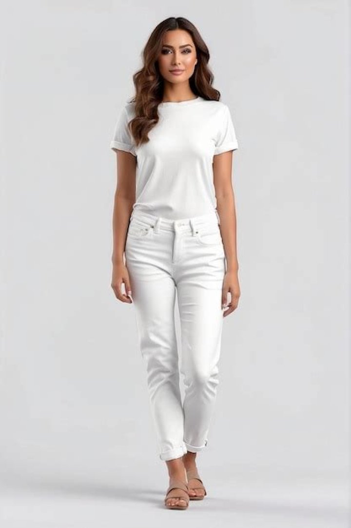 Woman in white pants and silk blouse stylish look