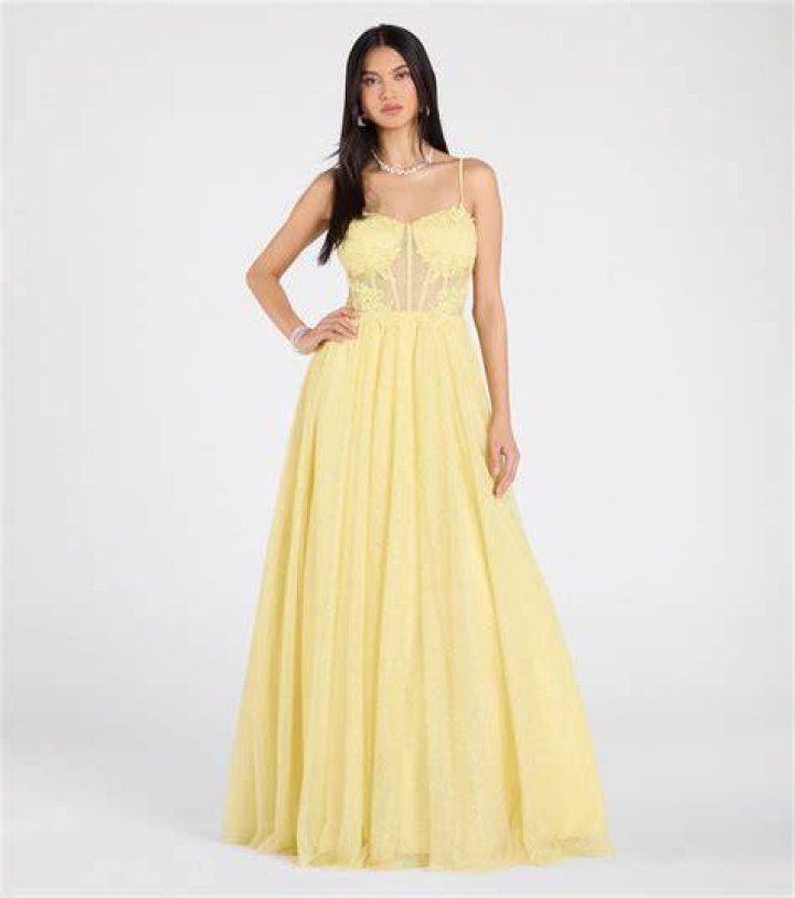Yellow A-line sundress with woven belt cinched at natural waist